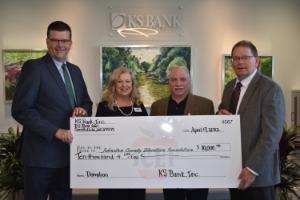 KS Employees and Johnston County Ed Foundation employees smiling with $10,000 check from bank